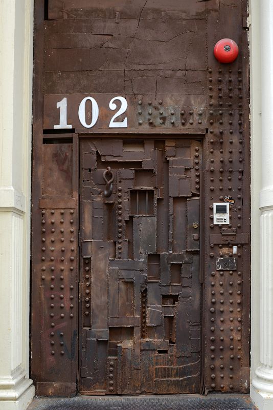 16-2 Steel Sculpture Door at 102 Greene St Designed by William Tarr - The hook Is The Door Knocker, the Barred Square Opens From The Inside In SoHo New York City